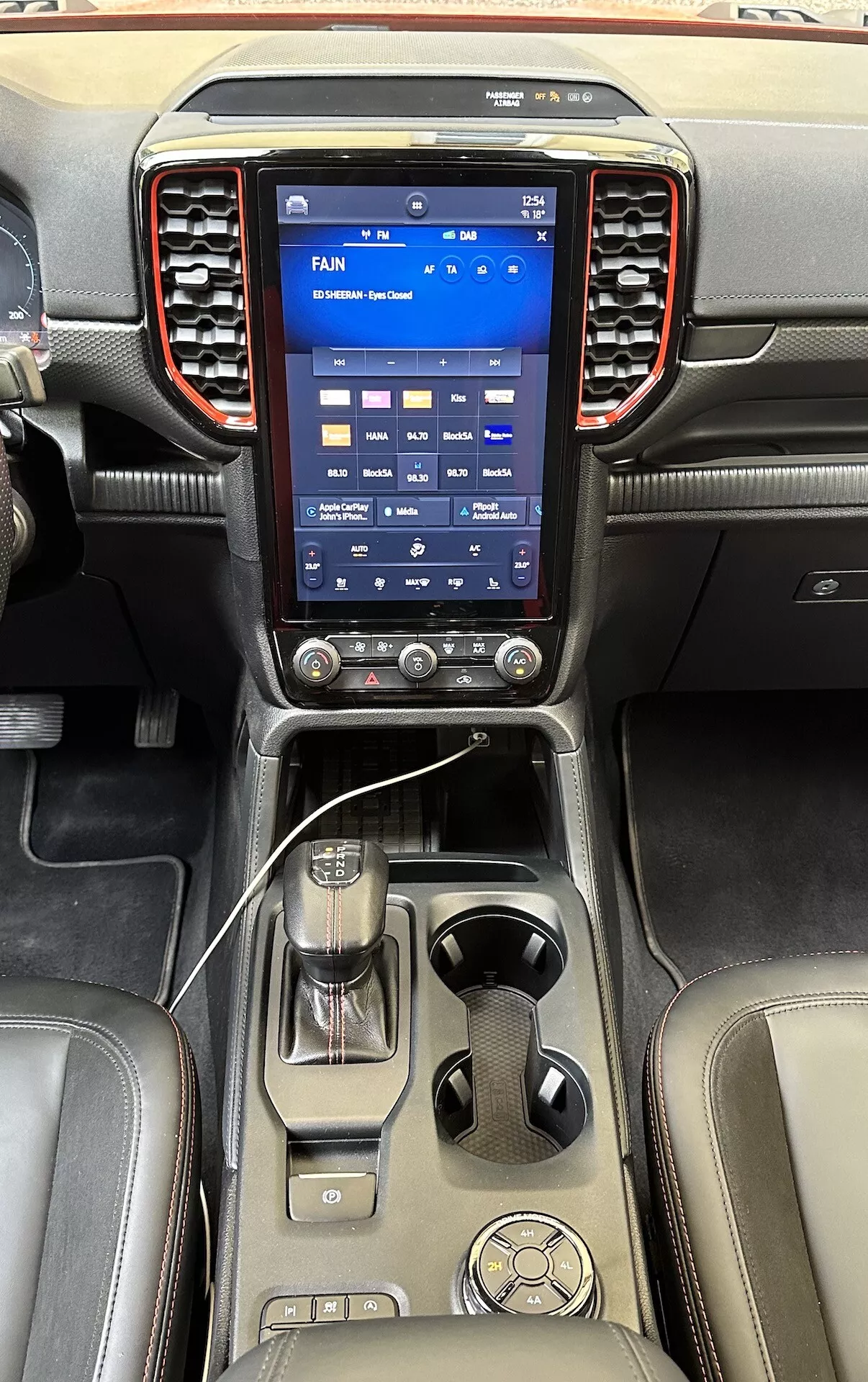 Sofistikovaná stredová konzola Ford Ranger 2022 s veľkým vertikálnym dotykovým informačným systémom, ovládačmi klímy, pákou automatickej prevodovky a luxusnými koženými povrchmi
