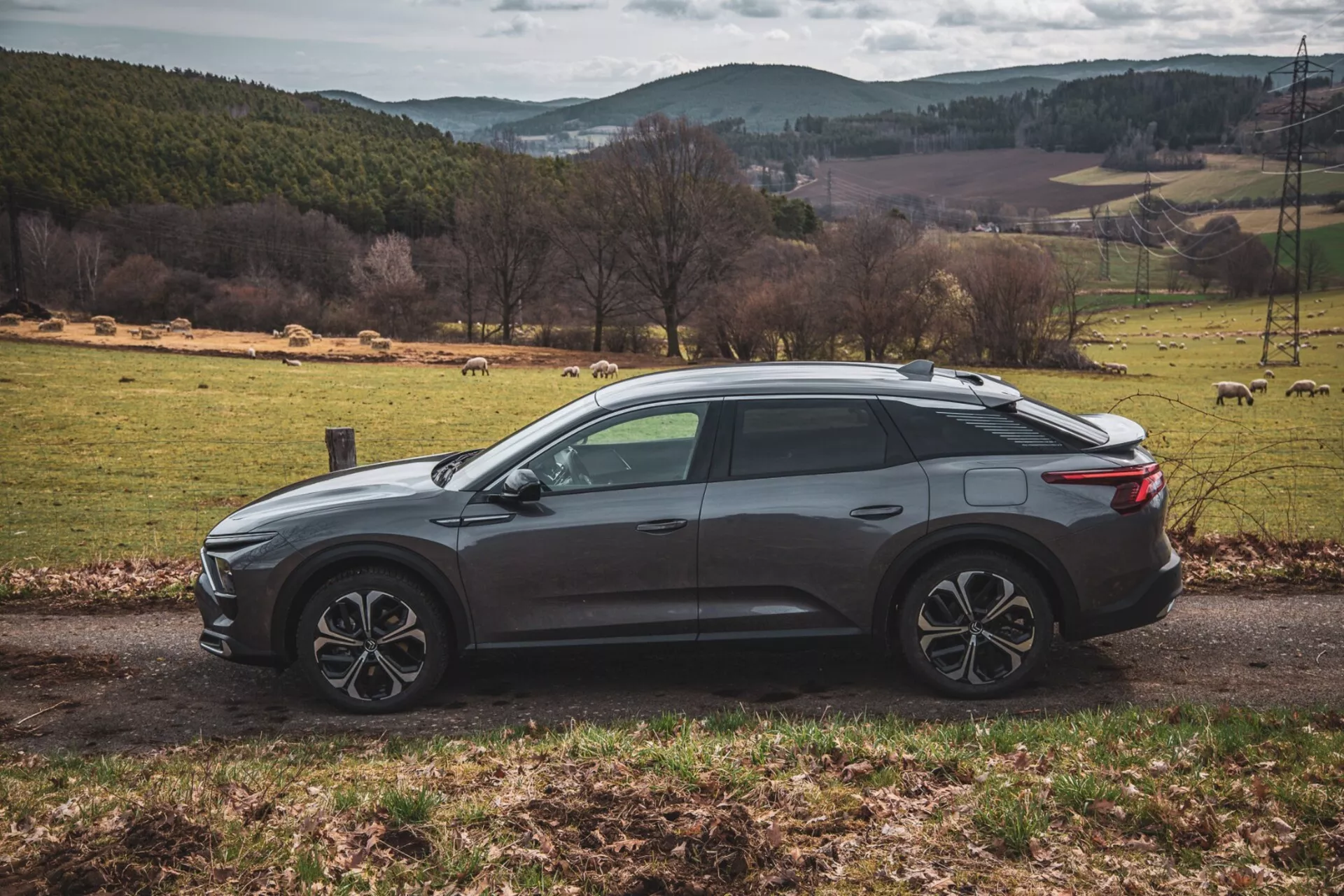 Citroën C5-X 2022 v elegantnej striebornej farbe, predvádzajúci svoj inovatívny dizajn a technologické funkcie na jasný deň