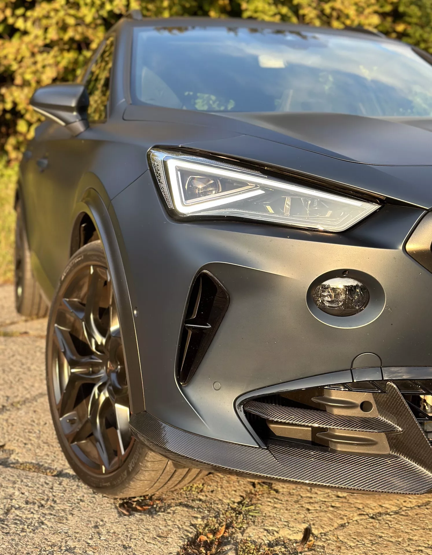 Detailný pohľad na prednú ľavú štvrtinu Cupra Formentor 2020 s LED svetlometom, profilovanou kapotou, predným nárazníkom zameraným na výkon a športovým zliatinovým kolesom