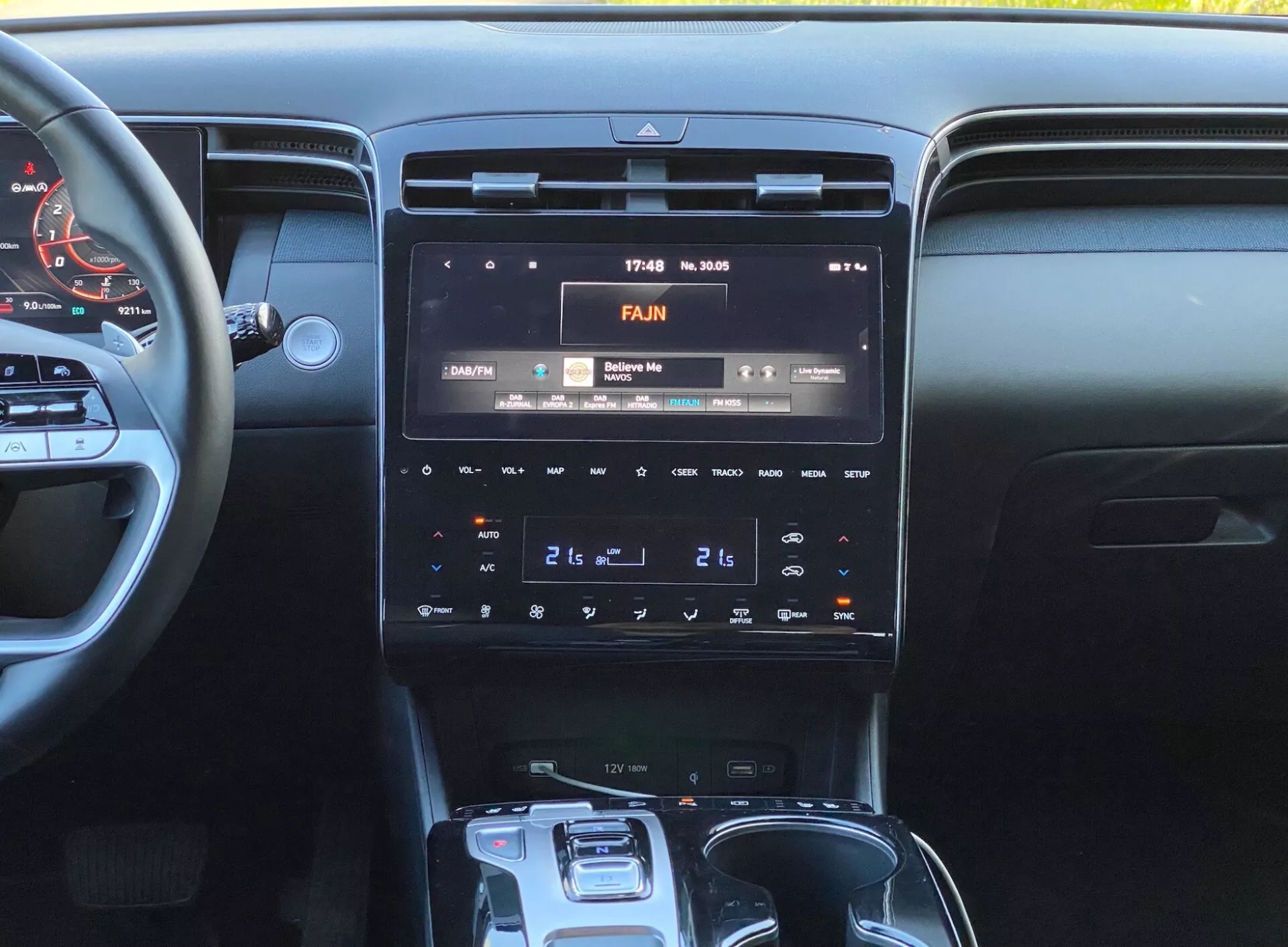 Obrázok interiéru Hyundai Tucson 2020, zameraný na stredovú konzolu s vysokým rozlíšením infotainment displeja zobrazujúci čas 17:43 a teplotu 30°C, panel dvojzónovej klimatizácie a automatickým voličom prevodovky.