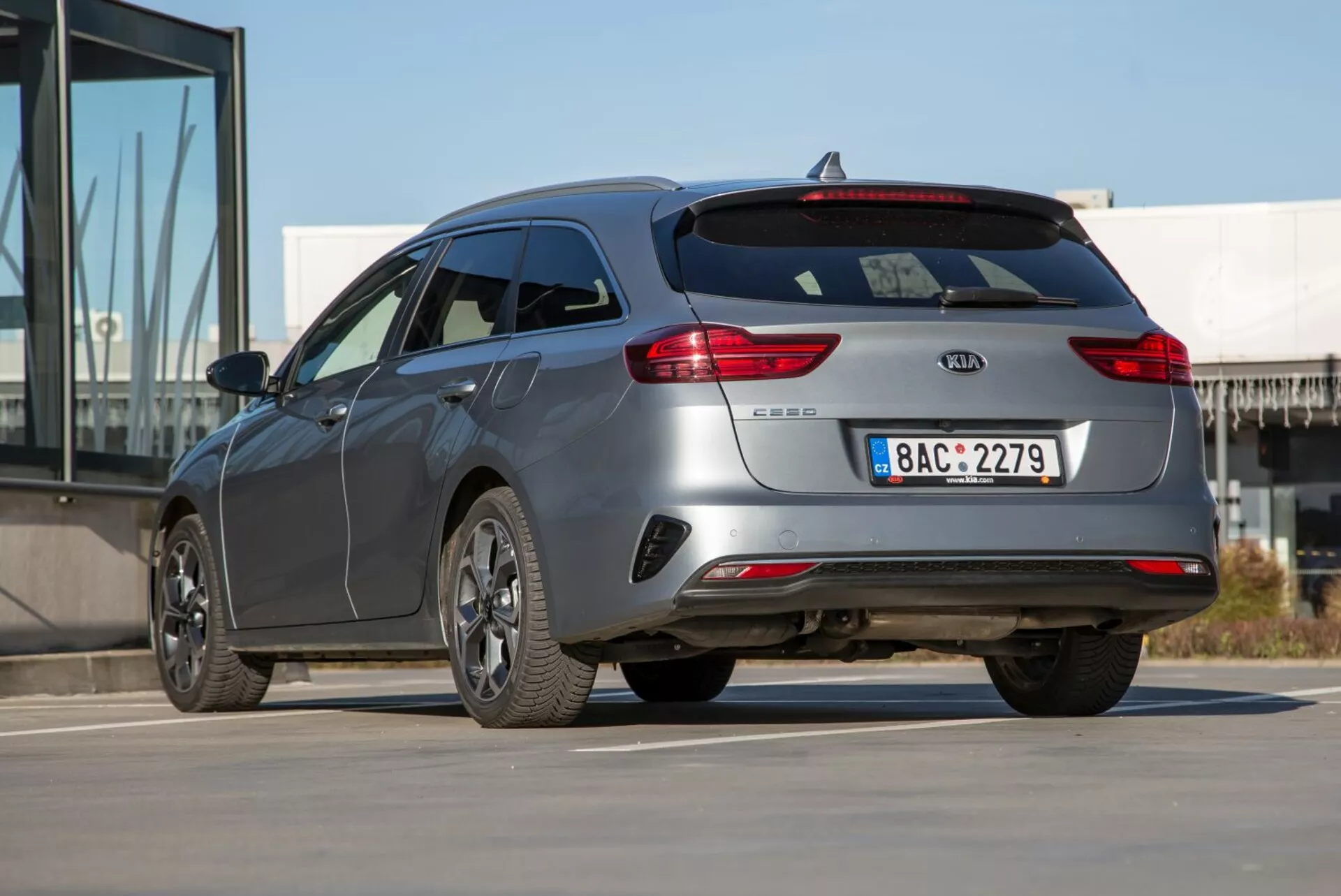 Station wagon Kia Cee'd 2009 v trojštvrťovom zadnom pohľade ukazuje elegantné krivky, moderný štýl, spoiler na batožinovom priestore a kolesá z ľahkej zliatiny s viacerými lúčmi