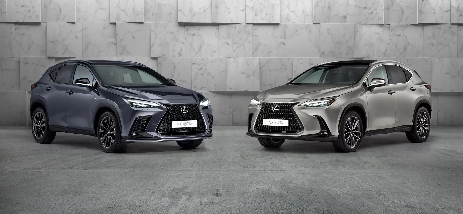 Obrázok zobrazuje dva autá Lexus NX 2021 v profesionálnom štúdiovom prostredí. Auto naľavo, tmavo zafarbené kompaktné SUV s výraznou agresívnou prednou mriežkou, ostrými LED svetlometmi a veľkými prívodmi vzduchu, je natočené, aby ukazovalo ľavú prednú a bočnú stranu. Kolesá sú otočené smerom k fotoaparátu, čím zdôrazňujú dizajn ráfikov. Auto vpravo, v svetlej kovovej farbe, natočené doľava, má podobný dizajnérsky jazyk s iným štýlom ráfikov. Obe luxusné SUV, umiestnené prominentne v rámci, vykazujú pokročilý dizajn a možné moderné technológie.