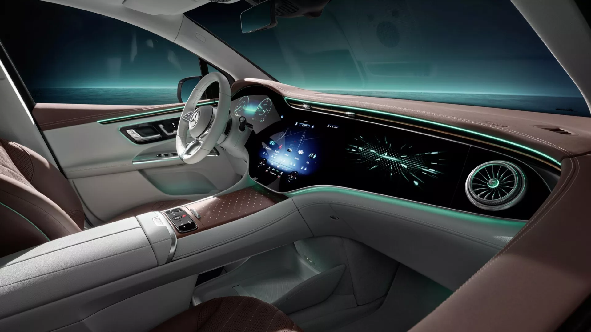 Interiér Mercedes-Benz EQE-SUV 2023 z pohľadu zadných sedadiel, predstavujúci minimalistický volant na ľavej strane, rozšírený digitálny palubný panel s displejom infotainmentu a ambientné osvetlenie, naznačujúci pokročilé luxusné a konektivitné funkcie
