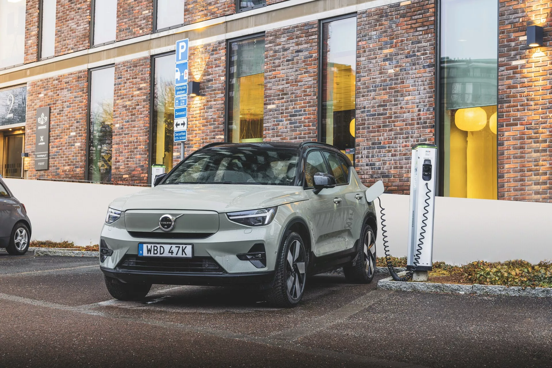 Elektrické vozidlo Volvo EX40 1. generácie z roku 2024 zaparkované pod uhlom, predvádzajúce elegantný dizajn a technologické prvky ako sú LED svetlá a nabíjacie porty, v mestskom prostredí