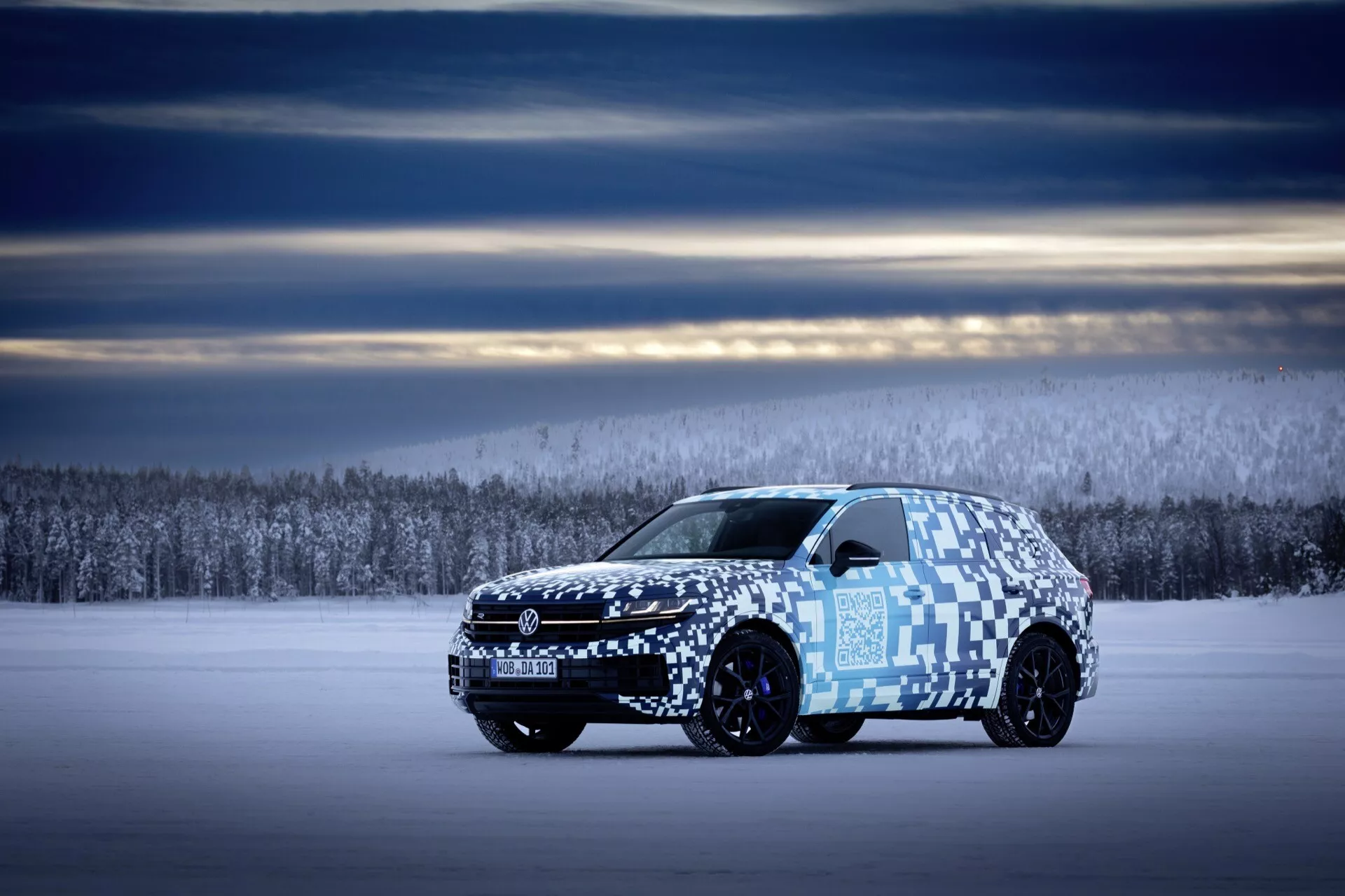 Bočný profil Volkswagen Touareg III facelift 2023 na zasneženom teréne s maskovacou fóliou, ktorý ukazuje dĺžku vozidla, aerodynamický dizajn a pokročilý svetelný systém